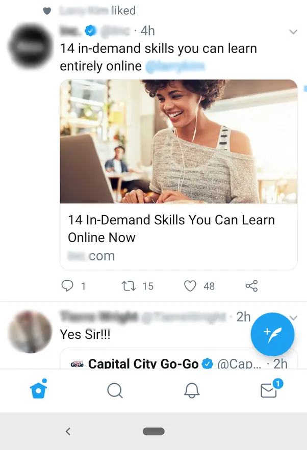 A Twitter screenshot showing a image of a woman using a laptop.